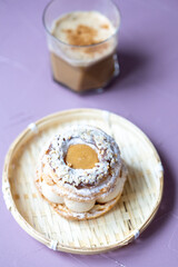 Close-Up of Pistachio and Pumpkin Christmas Paris-Brest Dessert with Pumpkin Latte

