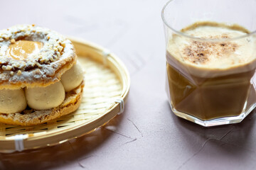 Close-Up of Pistachio and Pumpkin Christmas Paris-Brest Dessert with Pumpkin Latte
