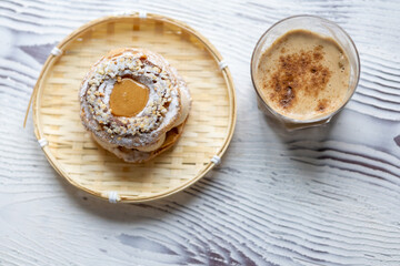 Close-Up of Pistachio and Pumpkin Christmas Paris-Brest Dessert with Pumpkin Latte
