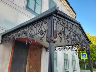 Ornate old wrought iron canopy over the door of an old house