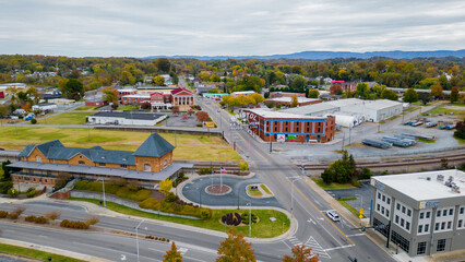 View of Bristol Tennessee Virginia Sign with train station and fall leaf change in background 