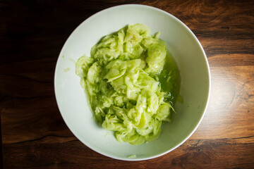 Cucumber salad in top view in the bowl