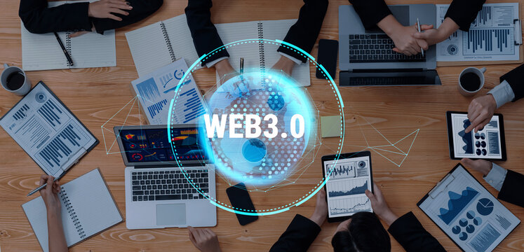 A diverse business team engaged in collaboration on Web3.0 strategies, analyzing data and trends with tablets and laptops during a dynamic office meeting. Trope