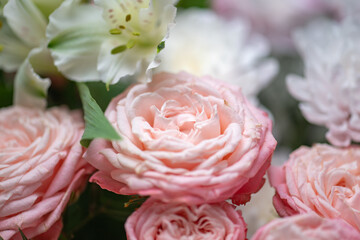 Spring bouquet of mixed flowers on vintage gray wall background behind