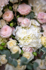 Spring bouquet of mixed flowers on vintage gray wall background behind