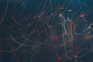 Bright streaks of light dance across the dark night sky in a vibrant urban scene captured during...