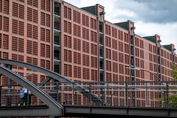View of the historic Speicherstadt district in Hamburg with its characteristic red brick warehouse facades and metal bridge structures