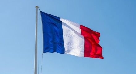 French national flag waving proudly against a clear blue sky