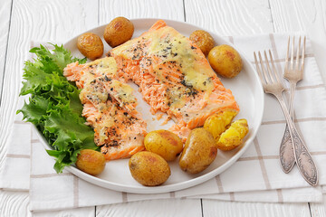 Salmon fillet with cheese, spices, baby potatoes