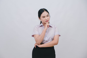 Thoughtful businesswoman in a professional outfit contemplating ideas against a plain backdrop with a confident demeanor and focused expression