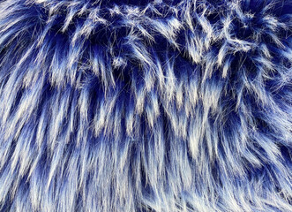 Natural fluffy fur texture. White blue color sheepskin rug background for design.
