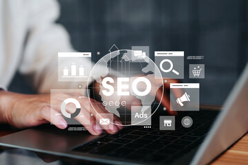 Businesswoman using laptop for analysis SEO icon to analyze search engine optimization for marketing and online traffic on website performance improvement rankings with strategic digital techniques