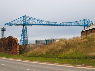The historic Transporter Bridge at Middlesbrough showing the waste land with wild grassland.