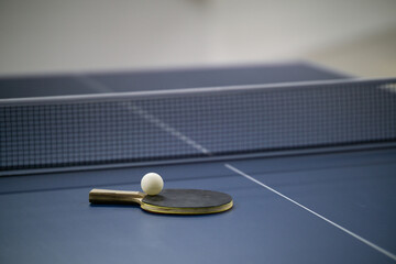 Table tennis racket and ball on table
