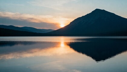 Sunset over lake and mountain silhouette