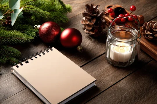 Holiday calendar mockup on wooden desk with Christmas decor