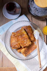 Pancakes with cottage cheese and raisin filling, served with honey and black tea. Traditional treat for Maslenitsa or Carnival.