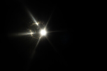 Lens Flare. Light over black background. Easy to add overlay or screen filter over photos. Abstract sun burst with digital lens flare background. Gleams rounded and hexagonal shapes, rainbow halo.
