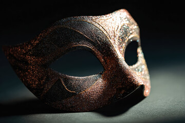 Naklejka premium Intricate masquerade mask adorned with glitter, capturing the essence of festive celebrations and New Year joy, showcasing elegance and mystery