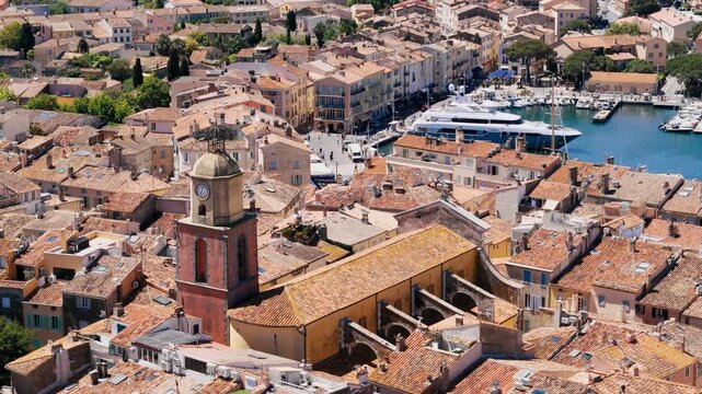 Aerial view of Saint-Tropez with Notre-Dame de l Assomption church tower rising above the old town on the French Riviera