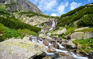 view of a waterfall in tatras mountains, slovakia
