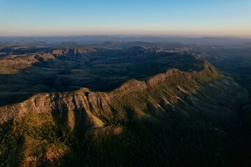 Aerial panoramic view of mountain ridges and valleys during golden hour in Brazil