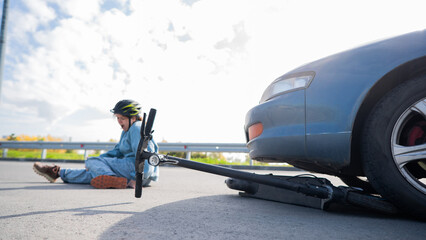 A Caucasian woman on a scooter after being hit by a car.