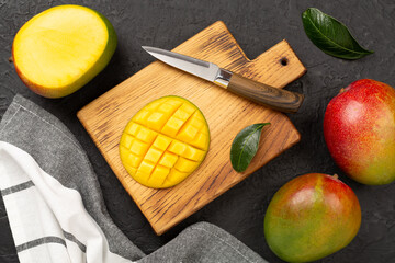 Fresh ripe mango on concrete background, top view