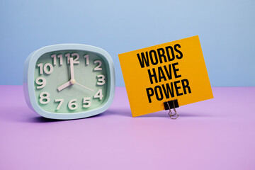 Words Have Power text and alarm clock on blue and purple background