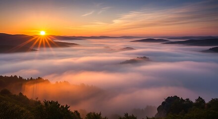 Sunrise over a misty mountain valley with golden light illuminating the fog