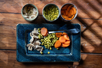 Servings of canned vegetables on a plate as a concept for National Canned Food Day.