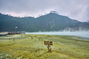 view of white crater with sulfuric gas in java in indonesia