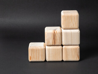 Wooden block staircase representing growth and success on black background