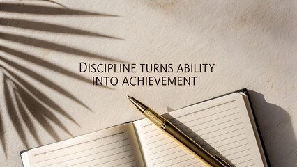 Motivational quote discipline turns ability into achievement with open notebook, golden pen, and sunlight shadow