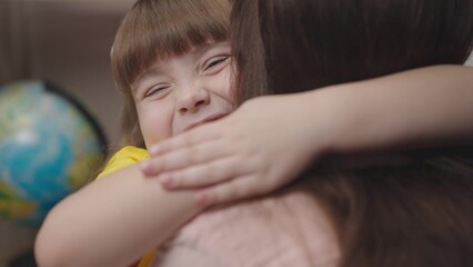little child hugs mom smiles. happy family life. parenting kid. mother love child daughter. concept children happiness. woman caresses child. child support kid. happy family together. girl close-up.