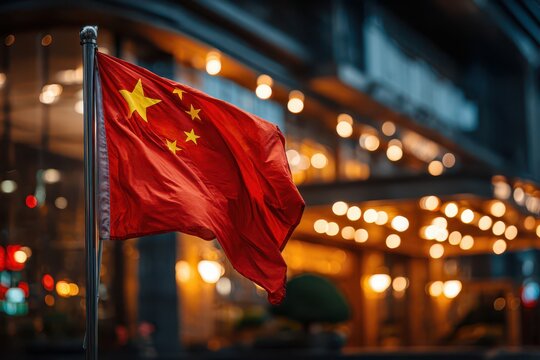 A Chinese flag waving in the wind against a blurred background of city lights, creating a patriotic scene with bokeh and vibrant colors, symbol of the nation