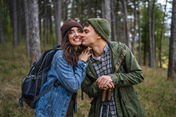 Fototapeta premium Young couple hiking in forest enjoying nature together