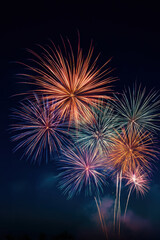 Vibrant festive multicolored fireworks illuminating the night sky
