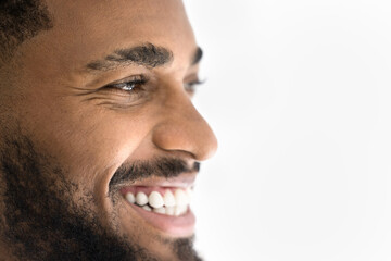 Closeup happy African man laughing, looking away, white background