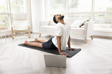 African man performing a cobra pose or Bhujangasana