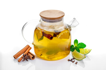 Teapot with citrus and mint with cinnamon and cloves. Glass teapot filled with citrus, mint, cinnamon, and cloves on white background, served warm and aromatic.