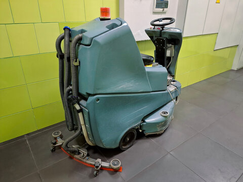 Self-propelled floor scrubber with operator seat. Ride-on floor scrubber machine