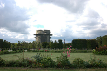 A view of the Flakturm in Vienna, Austria, with a garden in the foreground.