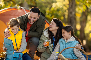 Family enjoys picnic in sunny park in autumn