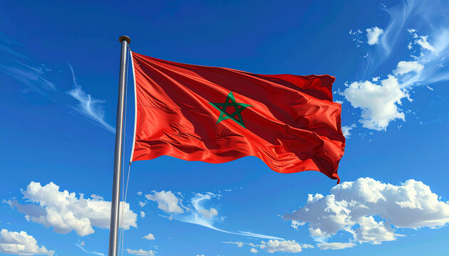 Vibrant Moroccan flag proudly waving against a clear blue sky with fluffy white clouds, symbolizing national pride and freedom.