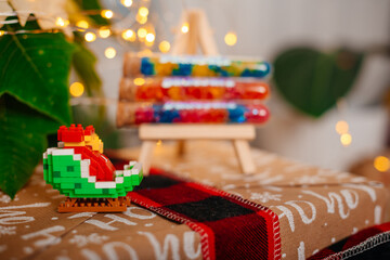 Festive Christmas scene with colorful toy bricks and glowing fairy lights creating a cozy holiday mood.