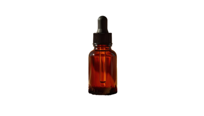Amber glass bottle with dropper, half full of light-reflecting liquid on a stark black background