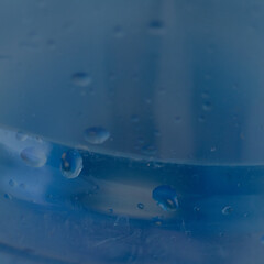 Deep Blue Water Droplets: Wet Glass Surface with Dark Underwater Texture