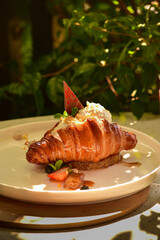 Gourmet croissant served with ice cream and elegant decorative toppings. A visually appealing image highlighting artisanal pastry, creamy ice cream, and a st