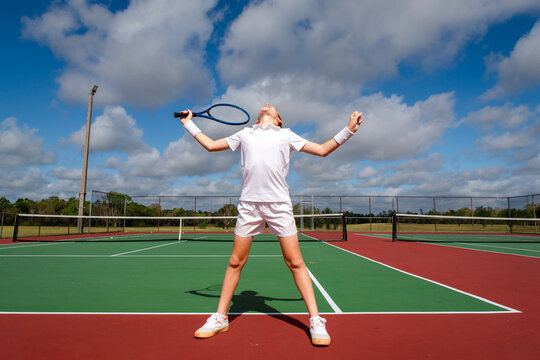 Male youth tennis player reacting emotionally after a thrilling and competitive match